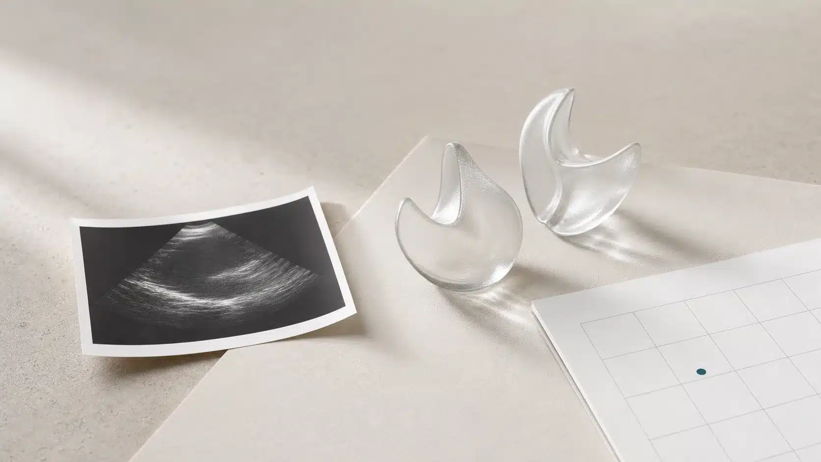 Echocardiogram image, abstract valve forms, and a blank monitoring calendar